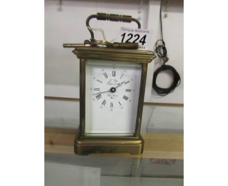 A brass carriage clock.