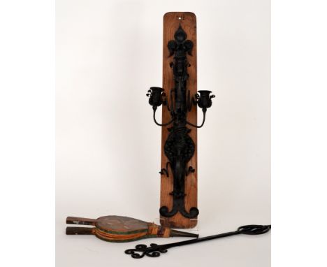 A 20th Century wrought iron three branch wall mounted candelabrum, mounted on an oak plinth together with a similar three pro