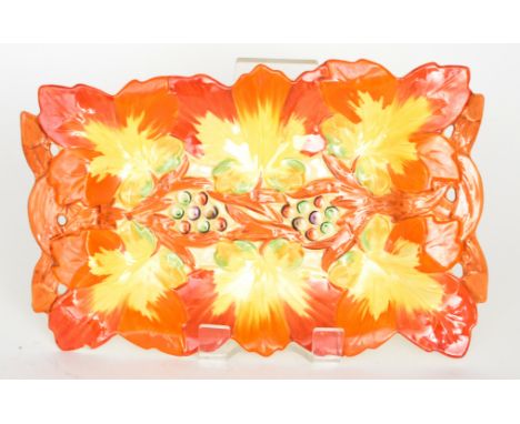 A large Clarice Cliff rectangular tray formed with relief moulded autumnal leaves and berries, hand painted in tones of orang