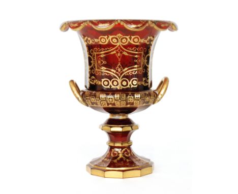 A large 19th Century Bohemian table centre bowl in the form of a campana urn with arched handles, decorated with gilded folia