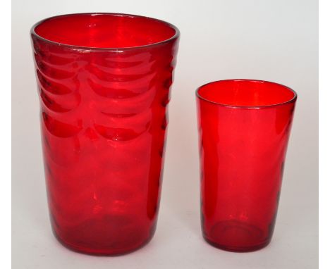 A large Whitefriars wave ribbed tumbler vase in ruby, height 29cm, together with a similar smaller example, height 21cm. (2)