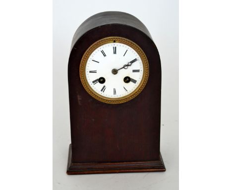 A 19th Century mahogany cased dome top mantle clock with white enamel dial and Roman numerals, lacking glass, height 23cm.
