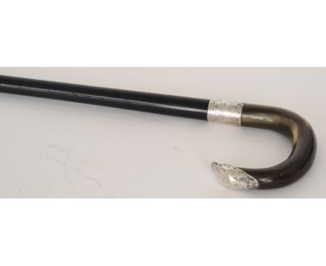 An Edwardian silver mounted horn handled walking stick, the ebonised stick terminating in brass ferrule, and having horn hand