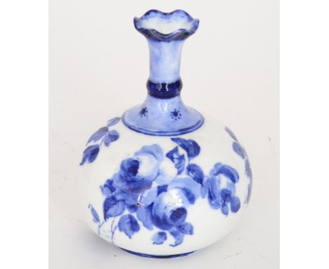 An early 20th Century Royal Crown Derby vase of globe and shaft form decorated with blue floral sprays against a milk white g