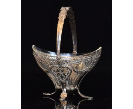 An early 20th Century silver plated swing handle sugar basin raised on four stylised pad feet, encompassing clear glass liner