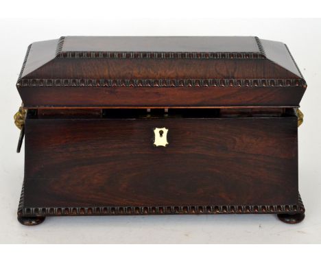 A 19th Century rosewood sargophical shaped tea caddy with gadrooned decoration, fitted interior on bun feet, width 34cm