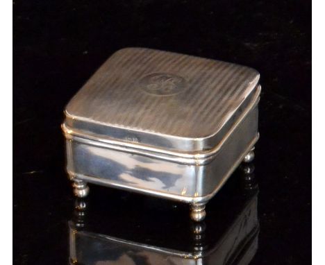 A George V hallmarked silver jewellery box, the square box with engine turned decoration and central monogrammed cartouche, h