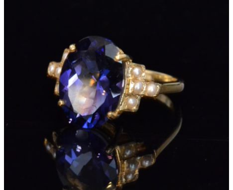 A 9ct hallmarked blueberry quartz and seed pearl ring, central oval claw set quartz flanked by four pearls to each shoulder, 