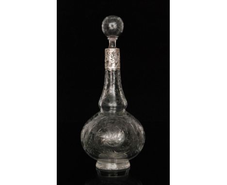 A late 19th Century Stourbridge crystal decanter of footed globe and shaft form with hollow blown spherical stopper, polished