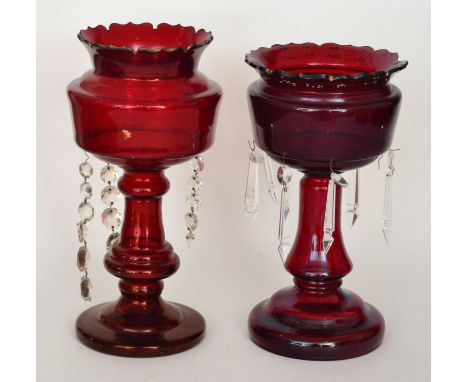 A near pair of 19th Century Continental ruby glass table lustres with a circular stepped foot, baluster form column and cup b