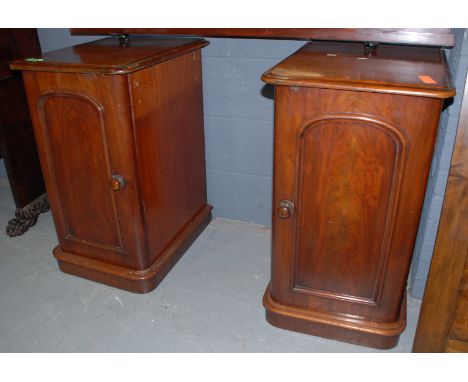 A pair over Victorian mahogany pedestal cupboards enclosed by arch panelled doors on plinth bases, width 42cm (2)