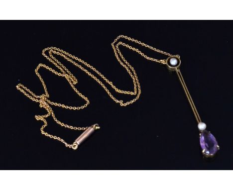 An Edwardian amethyst and seed pearl pendant, the pear shaped facet cut amethyst suspended from a gold bar with split pearl t