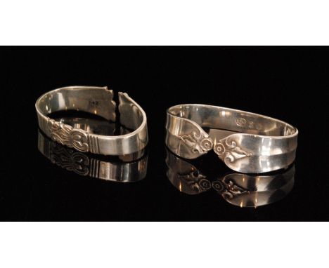 Two Danish silver napkin rings, each of oval form, one in the scrolls and lines design, pattern FRG13 hallmarked Poul C Lutke