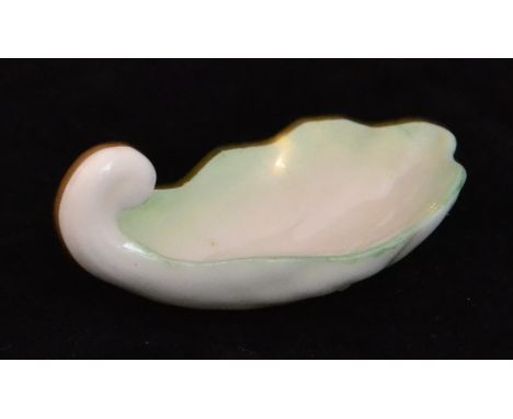 A late 19th Century Belleek tea caddy spoon formed as a muscle shell, length 4.5cm