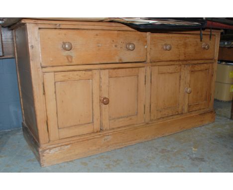 A 19th Century waxed pine two drawer dresser with cupboard plinth base, length 168cm