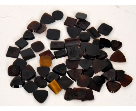 A large collection of 19th Century coloured glass intaglios, predominately dark or light brown carved with Romanesque helmete