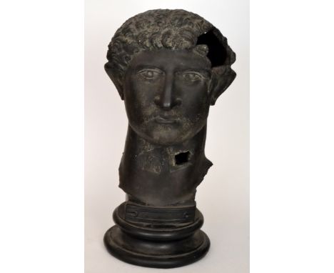 After the Antique - A reproduction ceramic bust of a Roman Emperor in dark patinated finish, raised to a socle base, unmarked