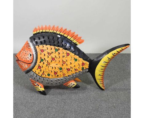 A large painted metal tea light holder, in the form of a fish, 90cm wide