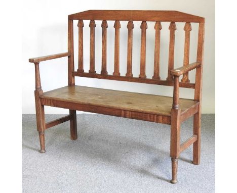 An Arts and Crafts period oak bench, with a slatted back and solid seat, on turned legs119w x 46d x 105h cmOverall condition 