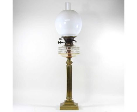A brass column oil lamp, with a white glass shade, 72cm high overall