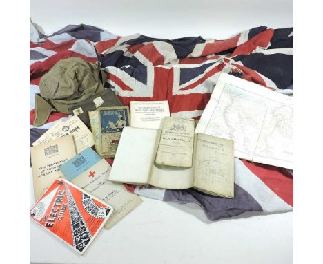 Three union jack flags, together with various ordnance survey maps, ration books, a military cap and an heraldic crest, paint