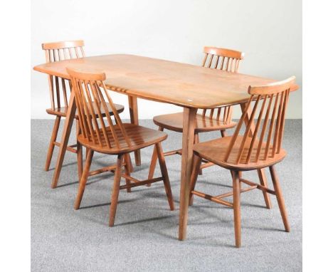 A 1960's Ercol light elm dining table, on a splayed base, together with a set of four Ercol style spindle back dining chairs1