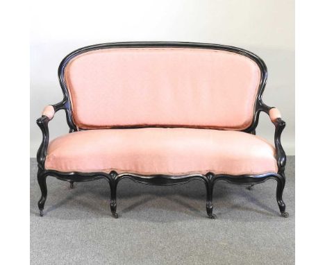 A 19th century ebonised and pink upholstered show frame sofa, of serpentine shape, on cabriole legs147w x 70d x 95h cm