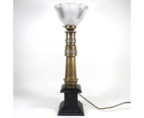 A brass table lamp, made from an early 20th century fireman's hose, with a holophane style frilled glass shade, 58cm high