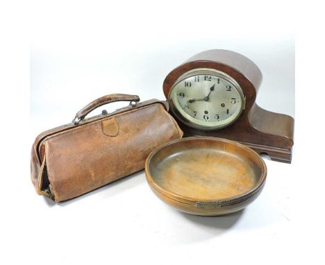 A mantel clock, 26cm high, together with a leather gladstone bag and a bowl with presentation plaque (3)