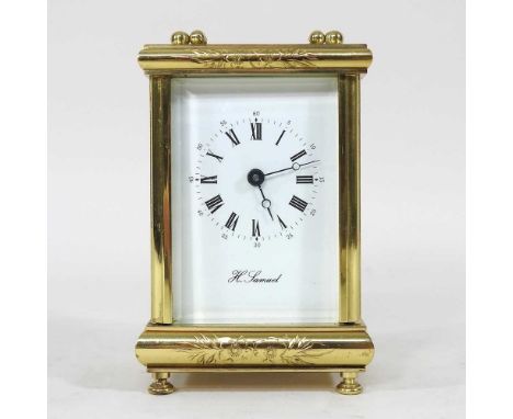 A mid 20th century gilt brass cased carriage clock, with a white enamel dial, 12cm high