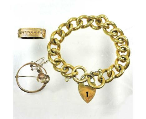 An antique 15 carat gold scarf clip, 5g, together with a 9 carat gold brooch, of circular shape, decorated with a flower, 4.3