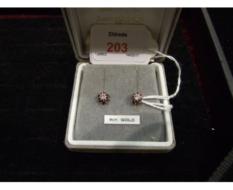 A pair of ruby and diamond cluster ear studs in 9ct gold mounts, 1.5g.