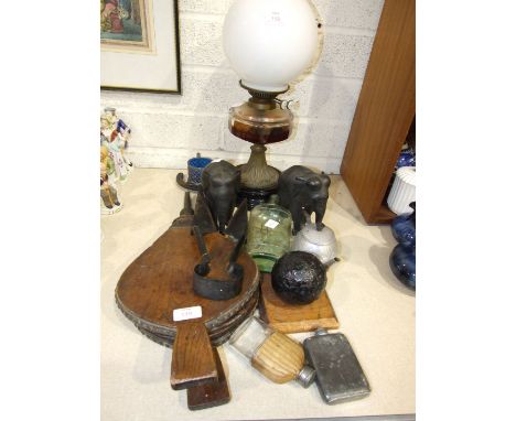 A late Victoria oil lamp, the faceted glass reservoir and short brass circular base on black ceramic base with opaque glass g