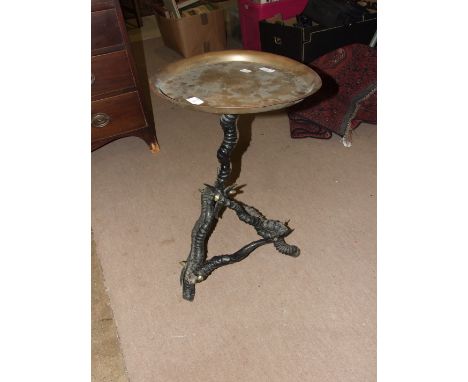 An unusual occasional table with brass tray top, on tripod support constructed from antelope horns, 62cm high, 39cm diameter.