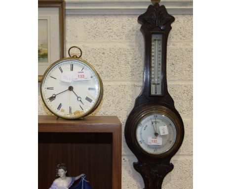 An oak framed aneroid barometer/thermometer, 54cm high and a brass drum mantel timepiece, dial af, 13.5cm diameter.