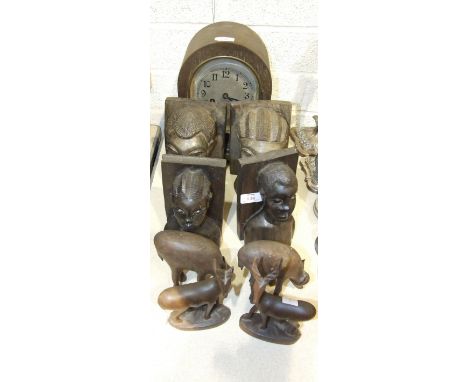 An oak cased dome topped striking mantel clock, 28cm high, two pairs of carved hardwood African bust bookends and two pairs o