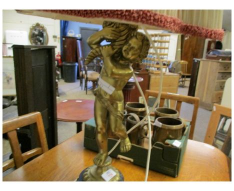 GILT METAL LAMP FORMED AS A PUTTI WITH A CREAM SHADE 