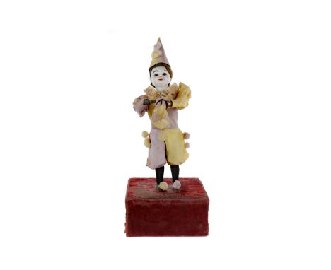 VICTORIAN AUTOMATON OF A GIRL, modelled dressed as a clown, playing a tune and pulling something from a sack when active, 44c