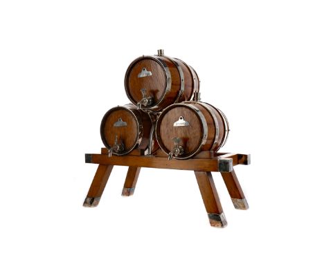 SET OF THREE VICTORIAN LIGHT OAK SPIRIT BARRELS ON STAND, with plated mounts, labels - Gin, Whiskey (sic) and Brandy, taps an