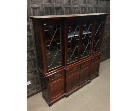 REPRODUCTION MAHOGANY BREAKFRONT BOOKCASE, with moulded dentil cornice over four astragal glazed doors flanked by fluted Cori
