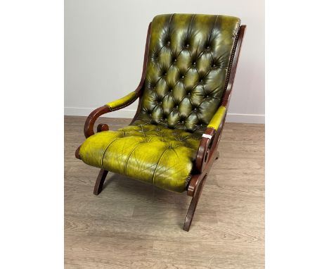 GREEN LEATHER BUTTON BACK LIBRARY ARMCHAIR, the curved back and seat flanked by two scrolling open arm rests, raised on mahog