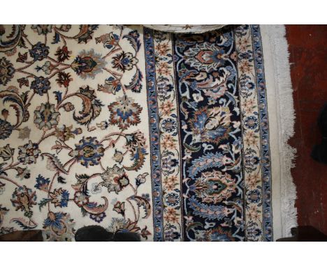 A Persian carpet with cream ground and floral motif 352 x 248cm £400-600