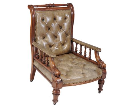 A Victorian mahogany and leather upholstered library chair, circa 1860, with turned top rail above rectangular button upholst