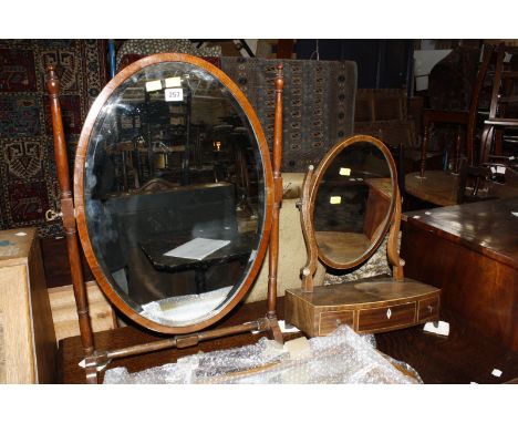 A George II style burr walnut fretwork mirror 68cm high 40cm wide, an oval swing toilet mirror, another the base with three d