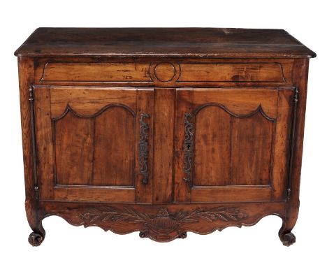 A French oak side cabinet, 18th century, the top with moulded edge above a carved frieze and two moulded panel doors enclosin