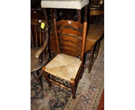 An ash ladderback kitchen chair with rush seat, a patinated metal six light chandelier and a turned wood lamp base (sold as p