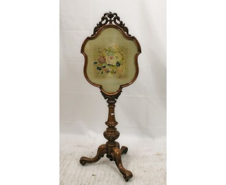 Victorian walnut pole firescreen, the pierced foliate cresting above shield frame inset with embroidered panel, the moulded c