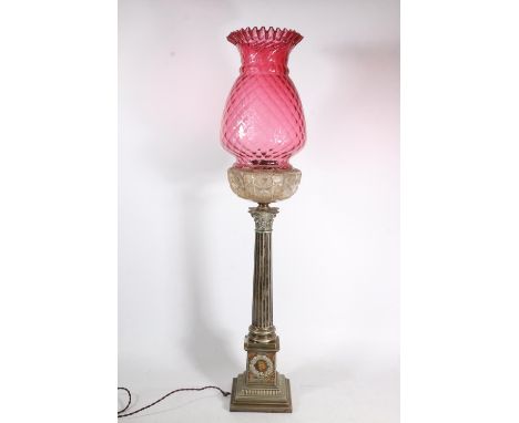 Victorian silver plated Corinthian column oil lamp base, the cranberry glass shade over clear cut glass font, reeded Corinthi
