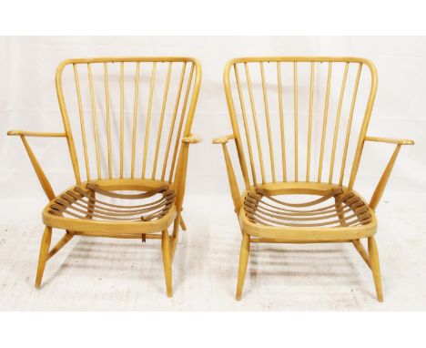 Pair of Ercol mid-century beech armchairs, the high hoop back rail leading to Windsor style spindle backrest and shaped arms,