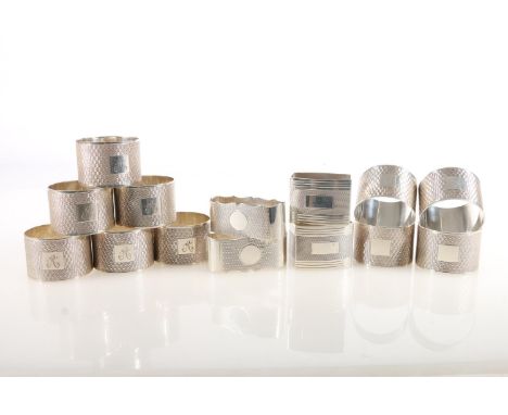 Set of ten George V silver napkin rings, the round bodies with engine-turned decoration and square cartouches, six with etche